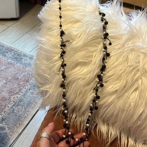 Long black, black shimmer and pearl necklace.